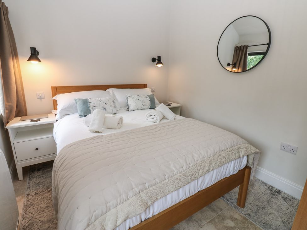 A bedroom with a bed and nightstands at Antoninus Barn 2 Ebchester