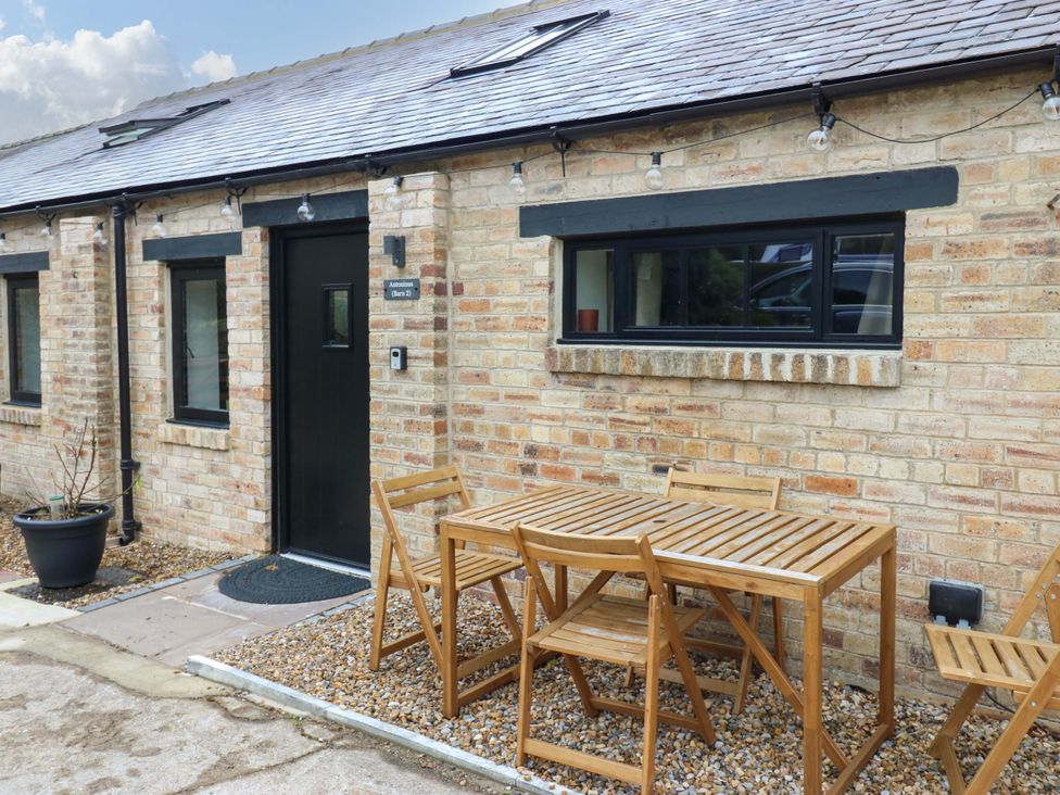 An outdoor seating area with a table and chairs at Antoninus Barn 2 Ebchester
