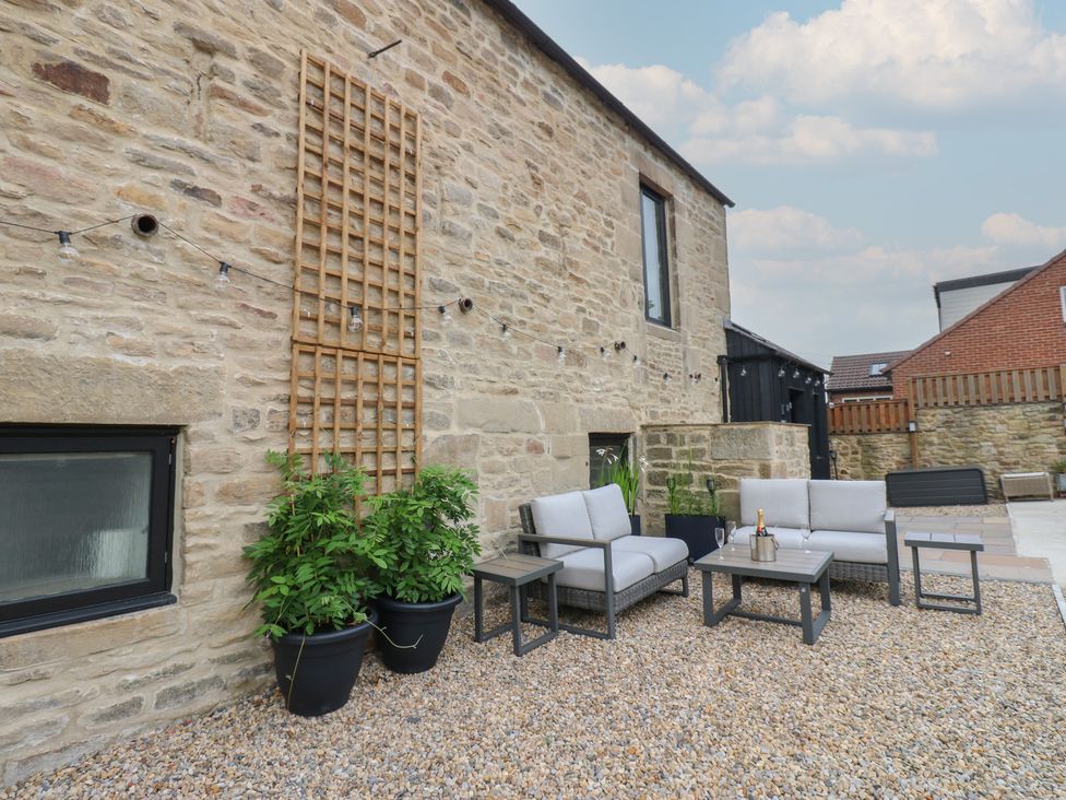 An outdoor seating area with chairs and tables at Marcus Barn 3 Ebchester