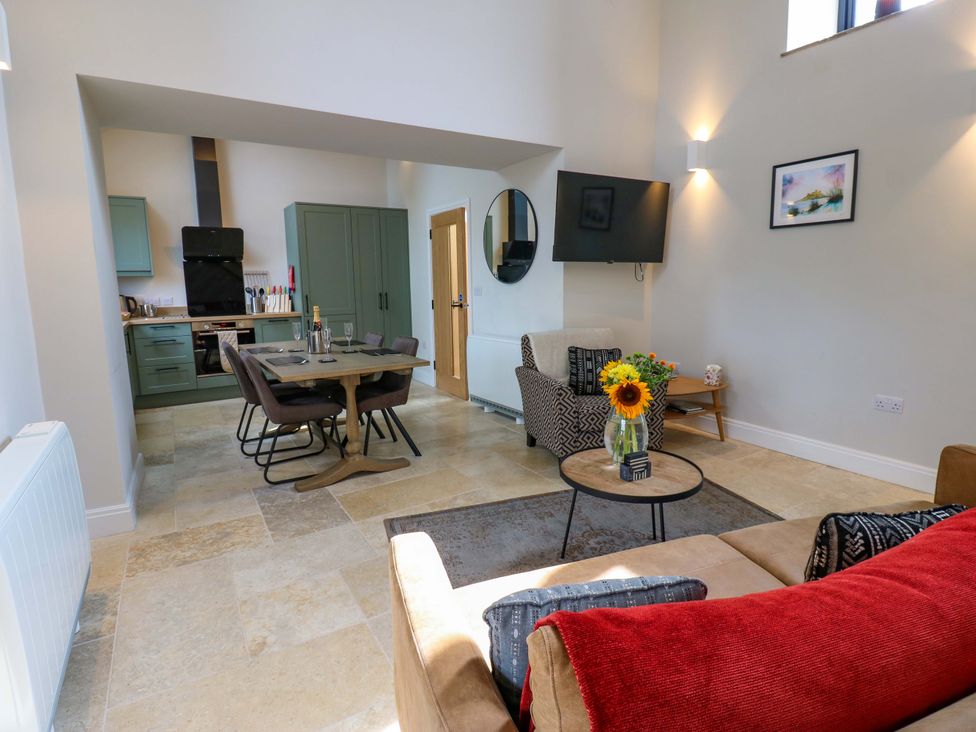 A living room with a dining area and kitchen view at Marcus Barn 3 Ebchester