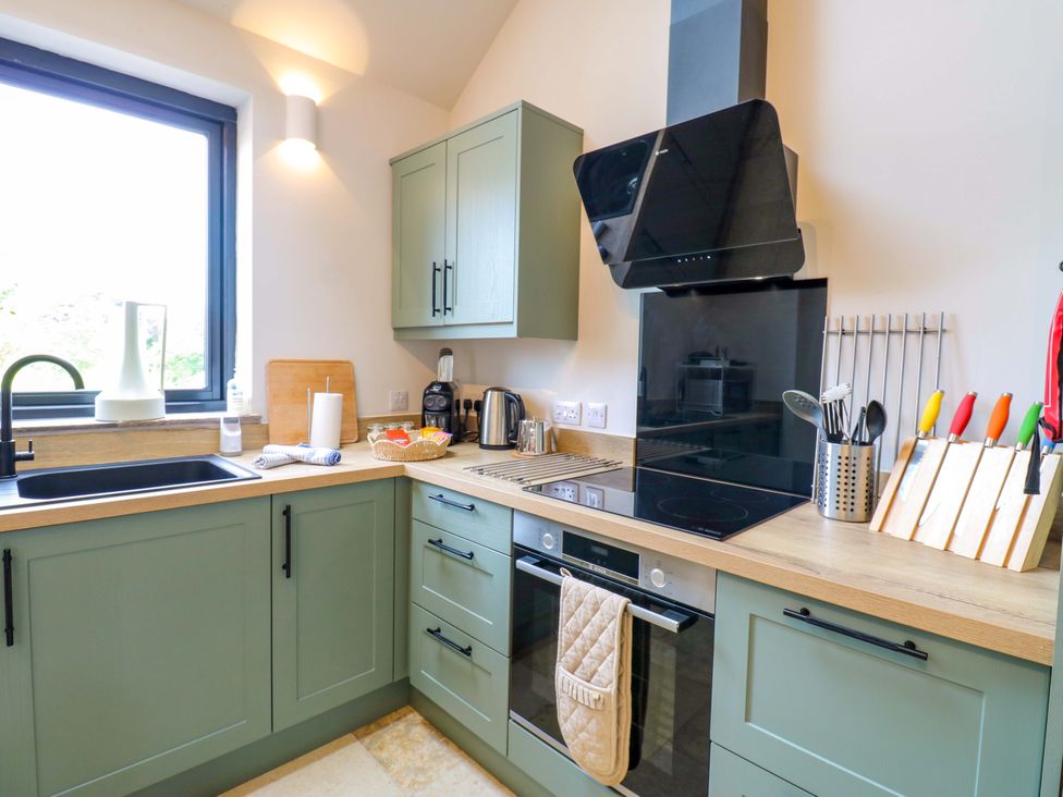 A kitchen with cabinets, appliances, and utensils at Marcus Barn 3 Ebchester