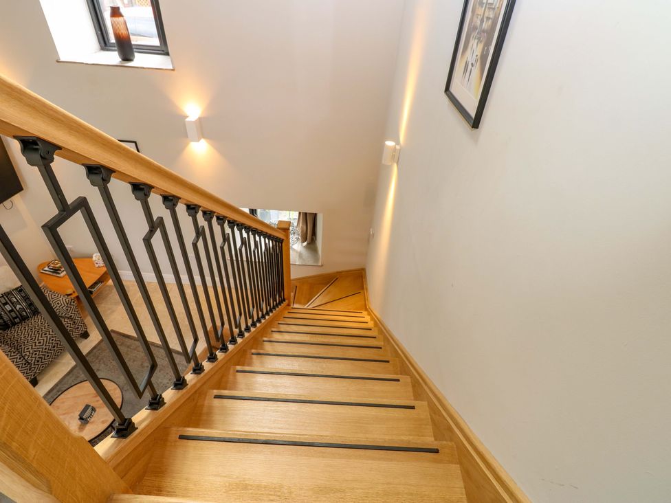 A staircase with wooden steps and railings at Marcus Barn 3 Ebchester