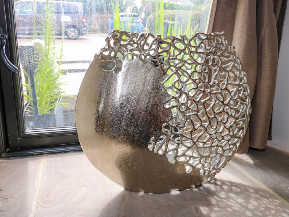 A decorative vase on a table near a window at Marcus Barn 3 Ebchester