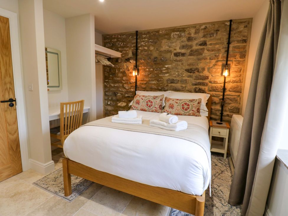 A bedroom with a bed and desk at Marcus Barn 3 in Ebchester