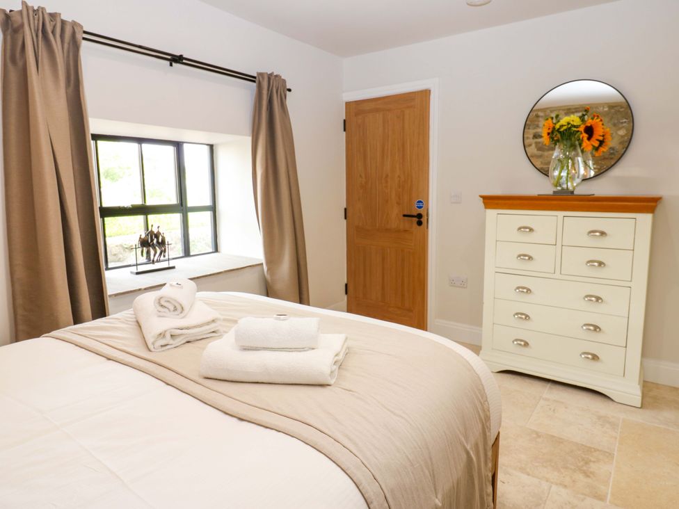 A bedroom with a bed and towels on it at Marcus Barn 3 Ebchester