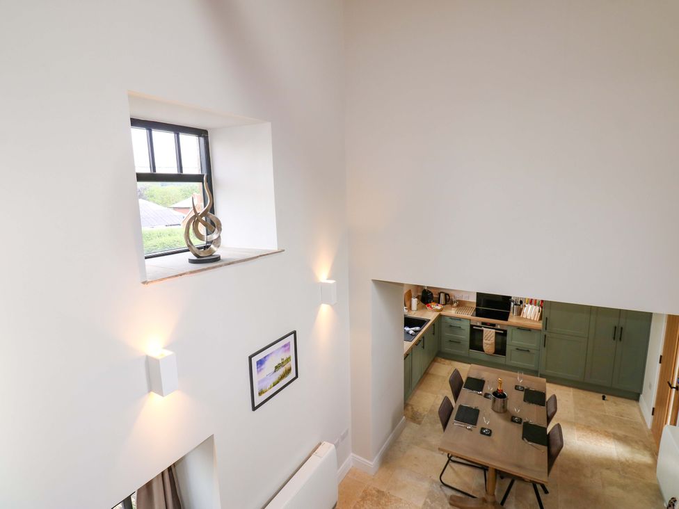 A kitchen with a table and chairs overlooking the space at Marcus Barn 3 Ebchester