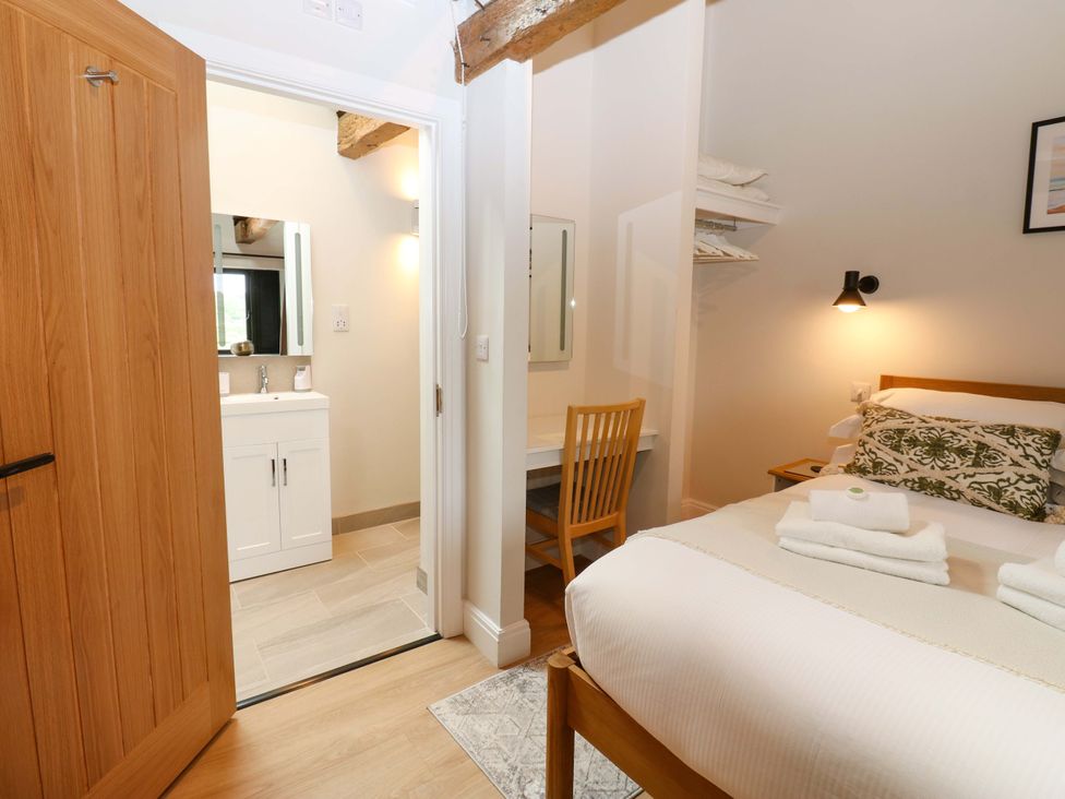 A bedroom with a bed and a bathroom area at Marcus Barn 3 in Ebchester