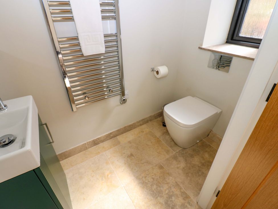 A bathroom with a sink, toilet, and towel rack at Marcus Barn 3 in Ebchester