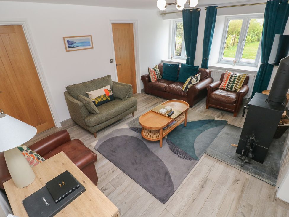 A living room with sofas and a coffee table at Folly Cottage Llanteg near Saundersfoot