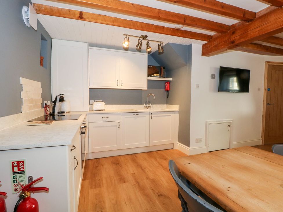 A kitchen with cabinets and a table at TOB Grave Prospect