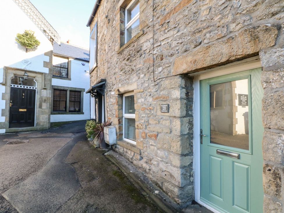 An entrance area with a stone wall and a door at TOB Grave Prospect