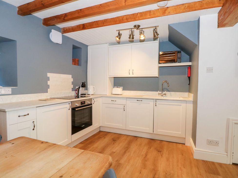 A kitchen with cabinets and appliances at TOB Grave Prospect