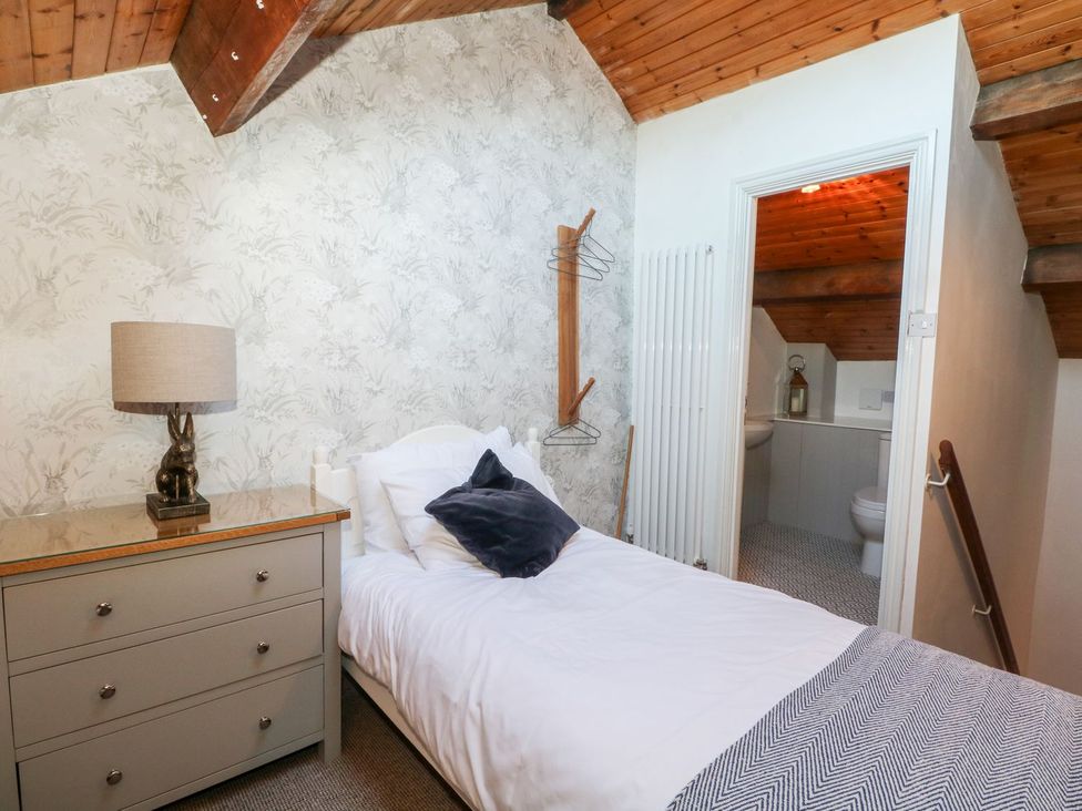 A bedroom with a single bed and dresser at TOB Grave Prospect
