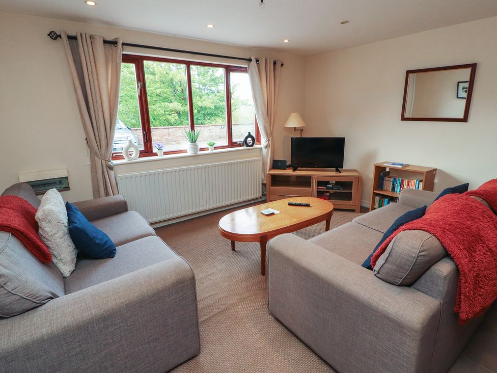 A living room with sofas and a television at Valley View in Cleator Moor