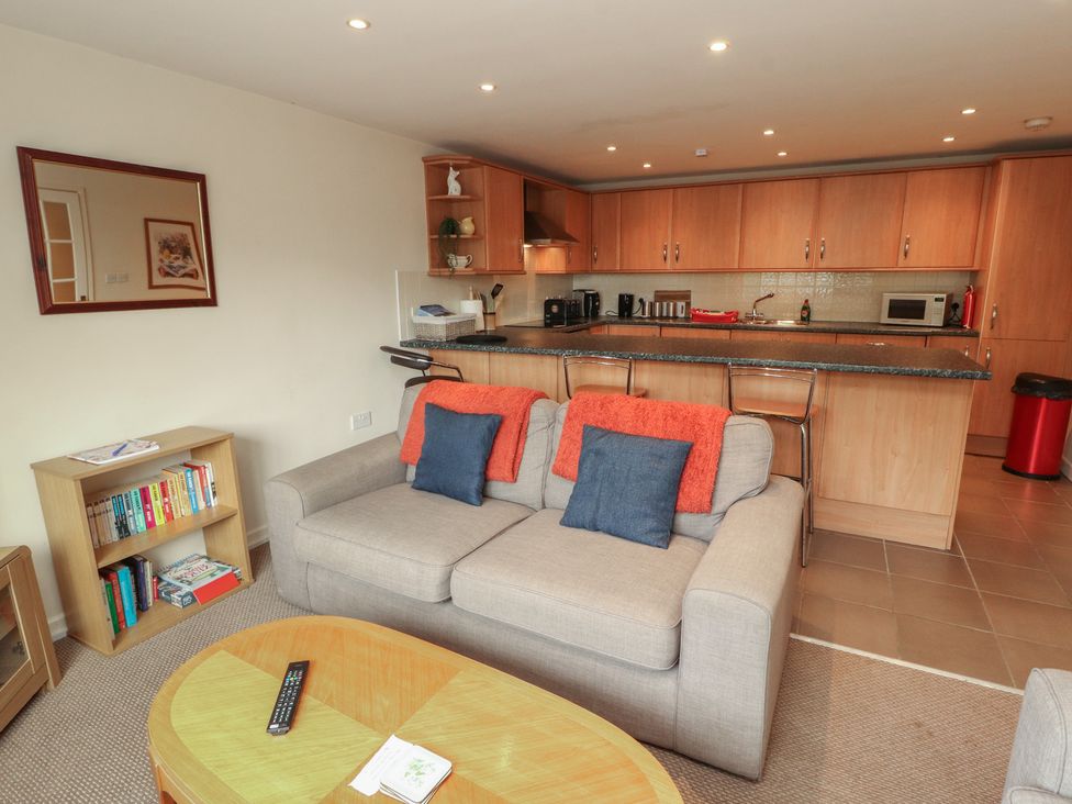 A living room with a sofa and kitchen area at Valley View in Cleator Moor