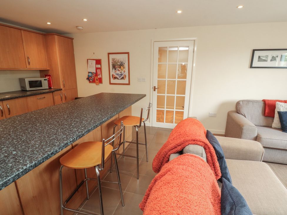 A kitchen with stools and a microwave at Valley View in Cleator Moor