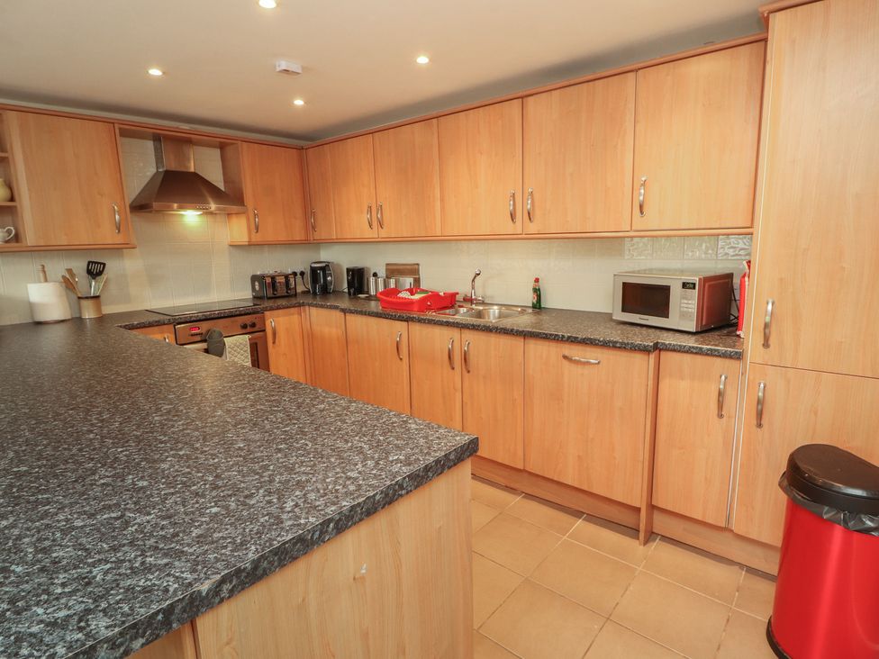 A kitchen with cabinets and appliances at Valley View in Cleator Moor