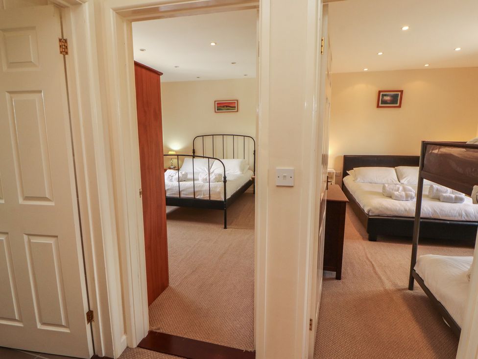 A bedroom with two beds and a bedside table at Valley View in Cleator Moor