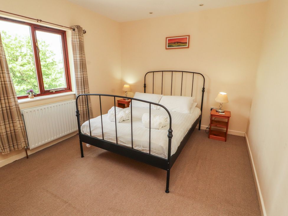 A bedroom with a bed and window at Valley View in Cleator Moor