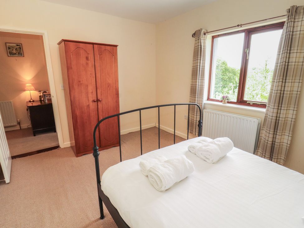 A bedroom with a bed and wardrobe at Valley View in Cleator Moor