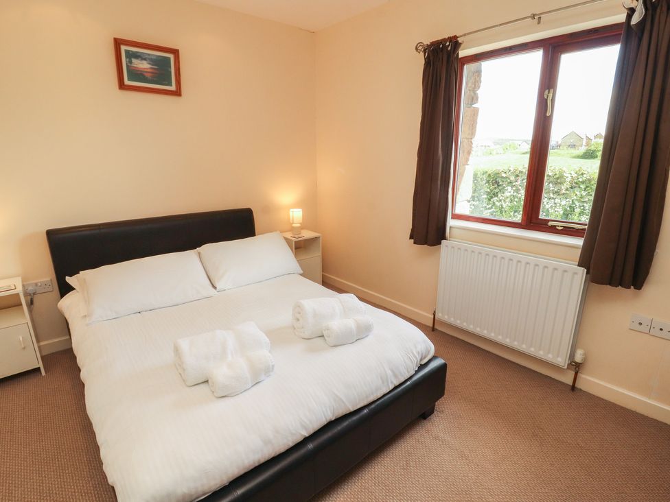 A bedroom with a bed and towels at Valley View in Cleator Moor
