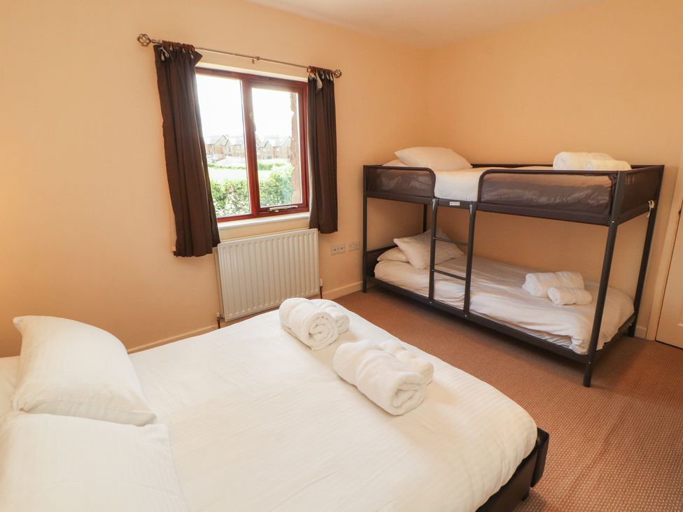 A bedroom with a double bed and a bunk bed at Valley View in Cleator Moor
