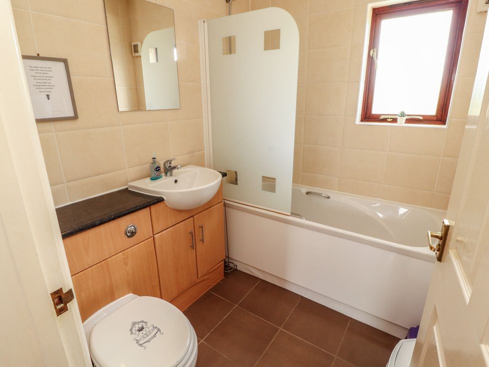 A bathroom with a sink, toilet, and bathtub at Valley View in Cleator Moor