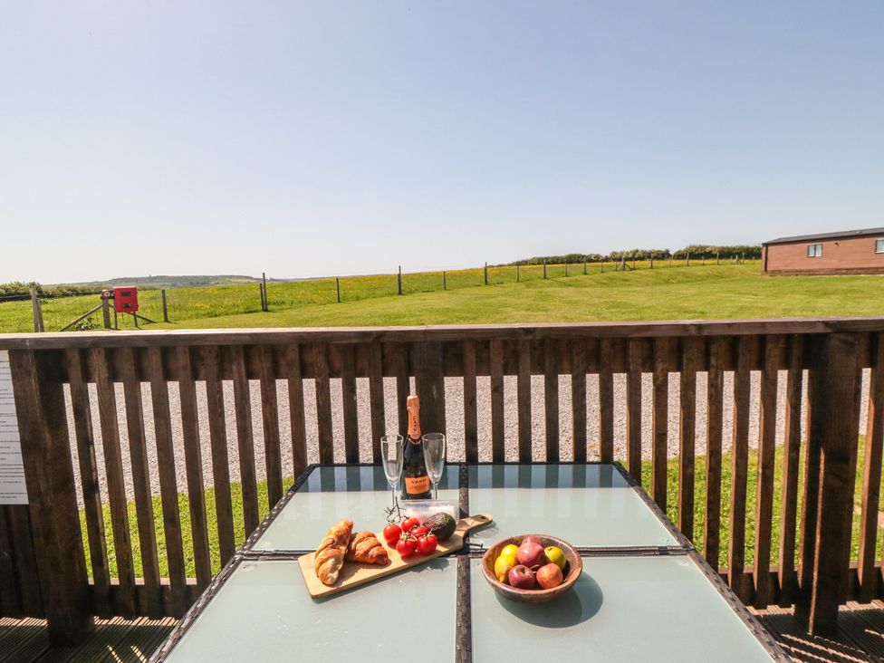 An outdoor table with food and drinks at Willow Lodge in Whitby