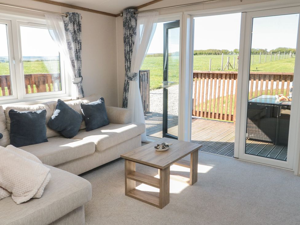 A living room with a sofa and coffee table at Magnolia Lodge in Whitby