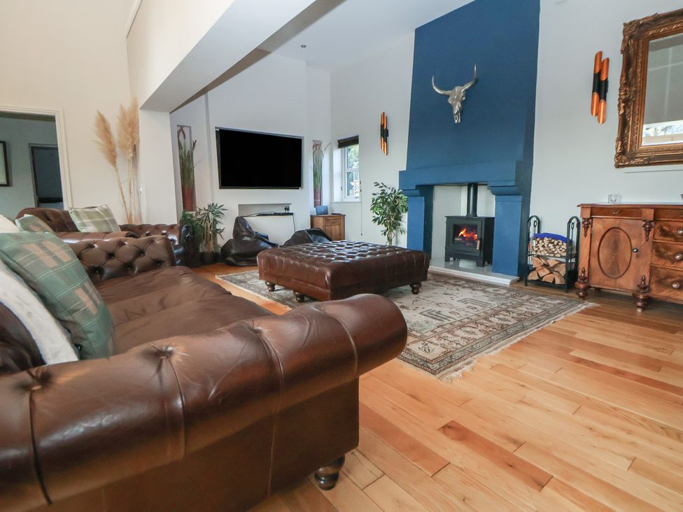A living room with a sofa and television at The Colonnade in Trefnant