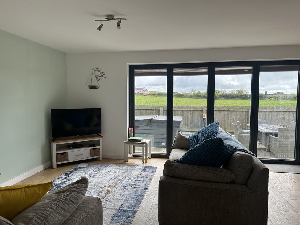 A living room with a television and couch at 9 Coastguard Cottages in Woolacombe