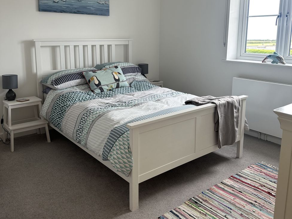 A bedroom with a bed and bedside tables at 9 Coastguard Cottages in Woolacombe