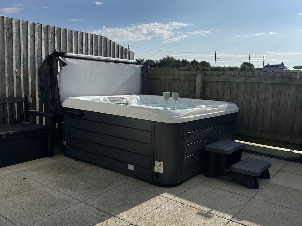 A hot tub with glasses on the side in an outdoor area at 9 Coastguard Cottages Woolacombe