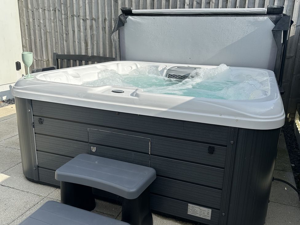 A hot tub with water and steps at 9 Coastguard Cottages Woolacombe