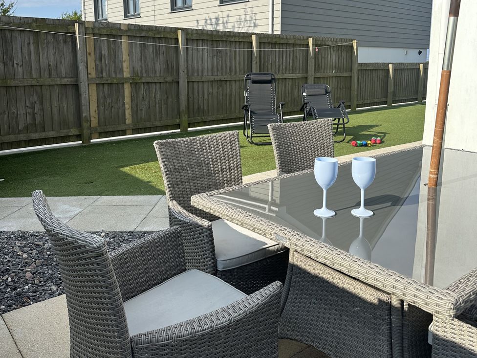 An outdoor dining area with a table and chairs at 9 Coastguard Cottages Woolacombe