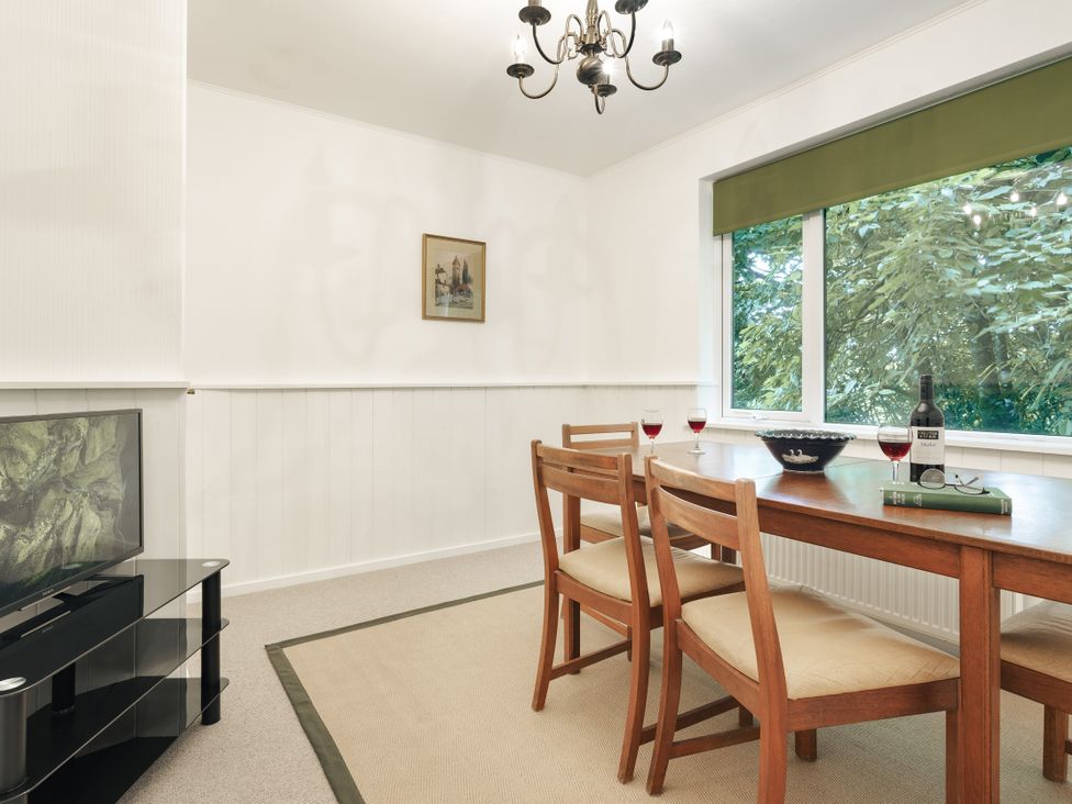 A dining room with a table and chairs at Tethers End in Lindeth near Bowness-On-Windermere