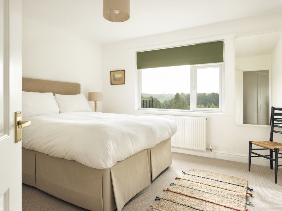 A bedroom with a bed and a window at Tethers End in Lindeth near Bowness-On-Windermere