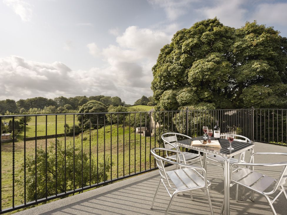 An outdoor patio with table and chairs at Tethers End in Lindeth near Bowness-On-Windermere