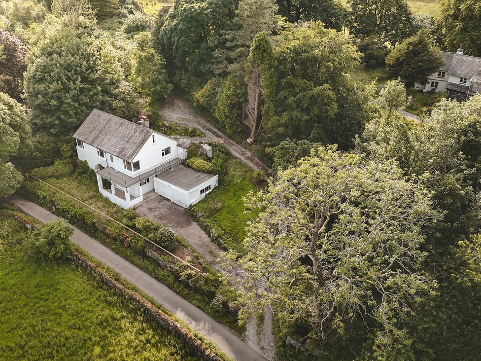 A house surrounded by trees and a garden at Tethers End in Lindeth near Bowness-On-Windermere