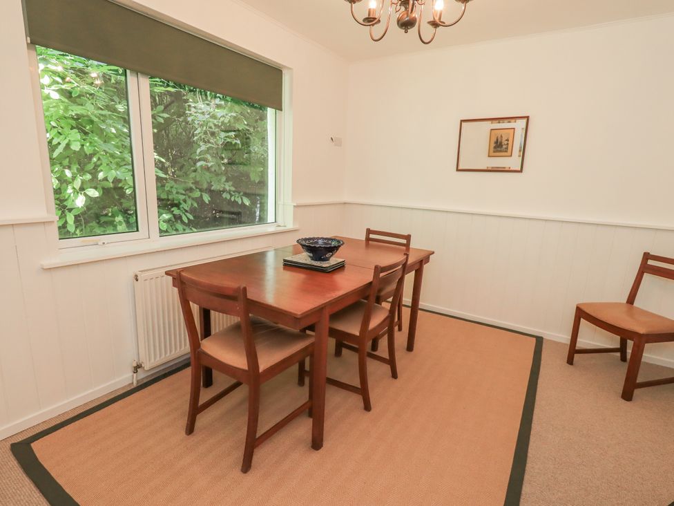 A dining room with a table and chairs at Tethers End in Lindeth near Bowness-On-Windermere