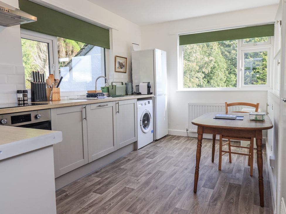 A kitchen with a sink and a washing machine at Tethers End in Lindeth near Bowness-On-Windermere