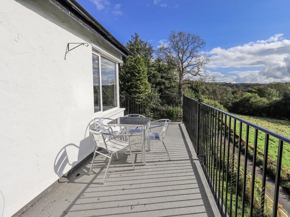 A balcony with a table and chairs at Tethers End in Lindeth near Bowness-On-Windermere
