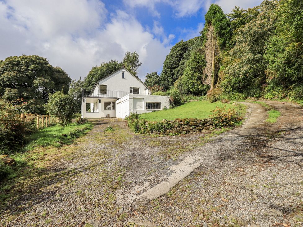 A house with a driveway and garden at Tethers End in Lindeth near Bowness-On-Windermere