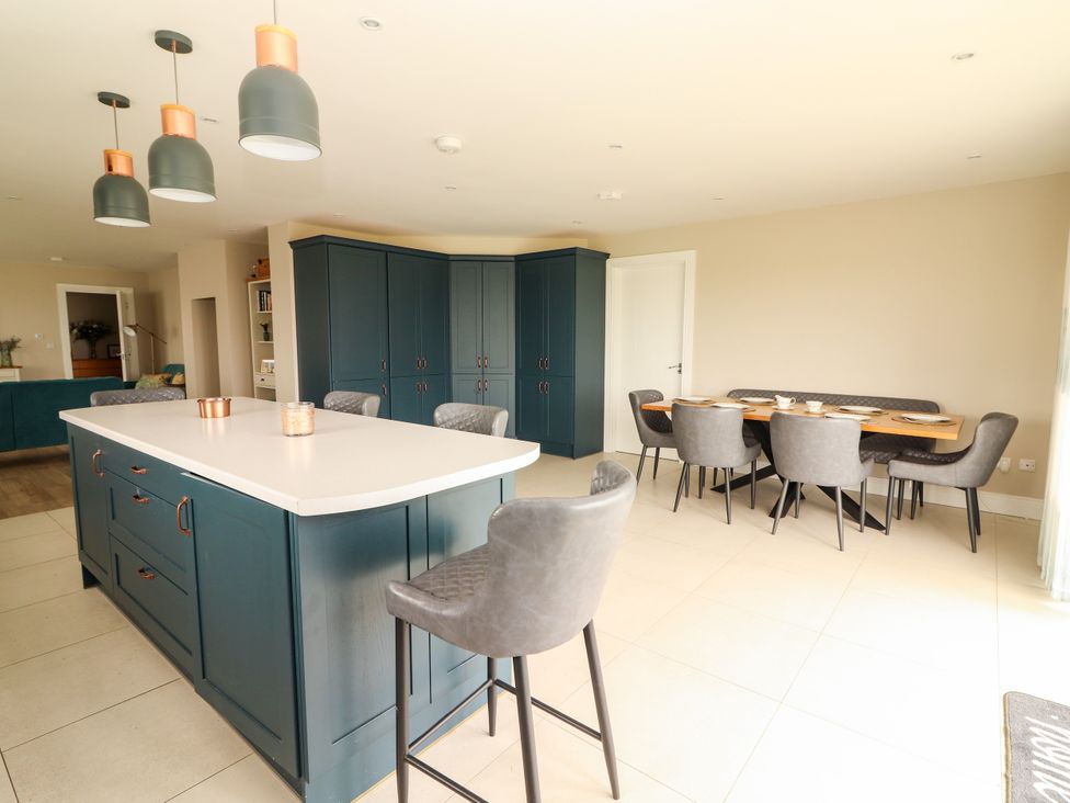 A kitchen with a dining table and chairs at Carrowmore North, Doonbeg, County Clare