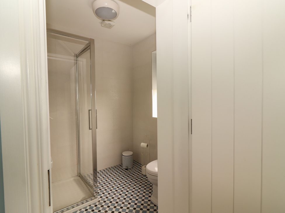 A bathroom with a shower and toilet at Carrowmore North in Doonbeg, County Clare