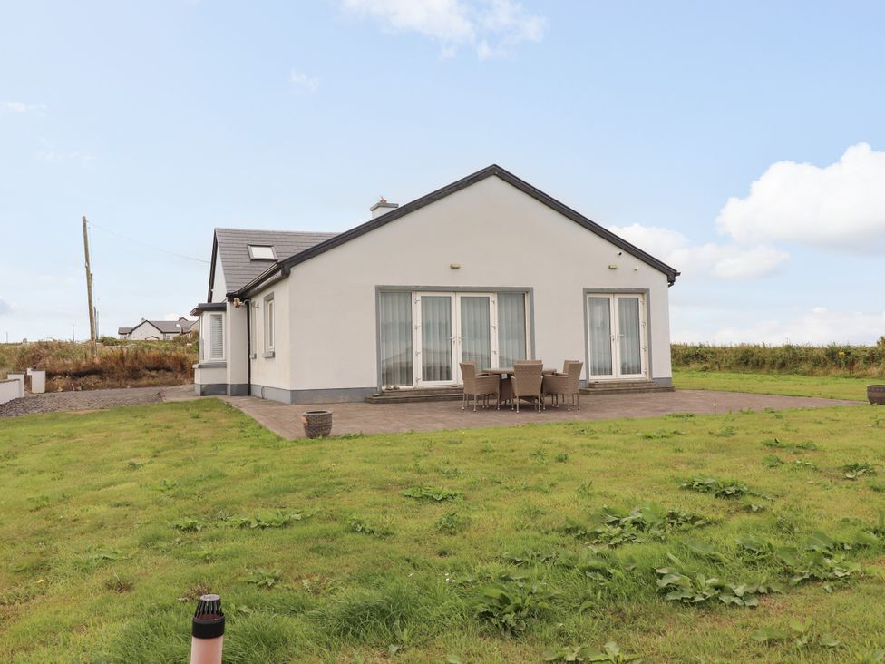 A house with a patio and outdoor seating at Carrowmore North in Doonbeg, County Clare