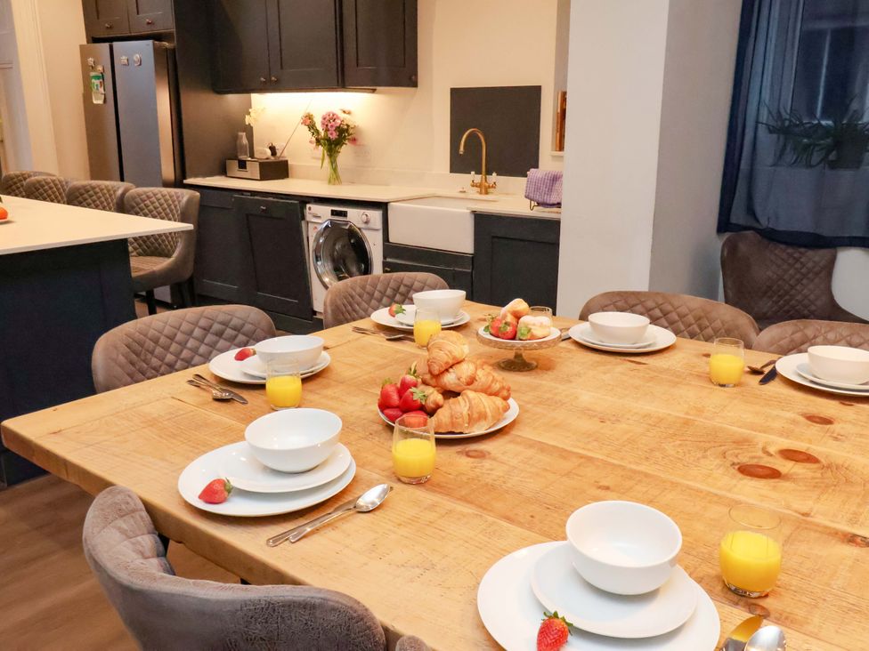 A kitchen with a dining table set for breakfast at Wellington Lodge in Bridlington