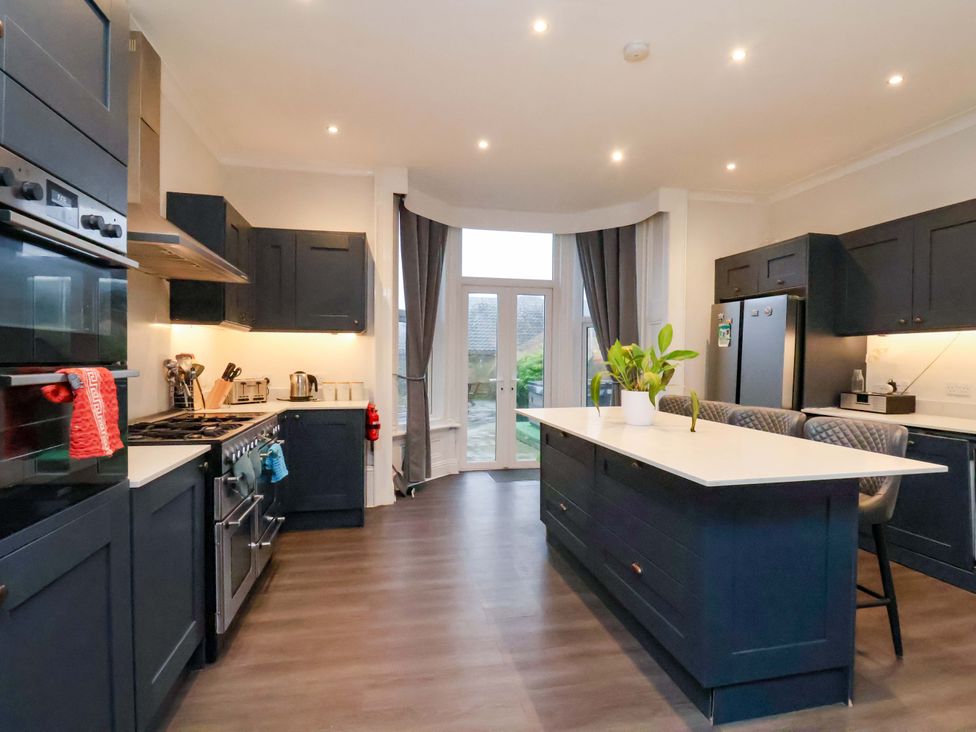 A kitchen with cabinets and appliances at Wellington Lodge in Bridlington