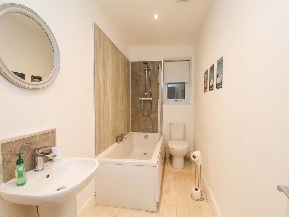 A bathroom with a bathtub and sink at Wellington Lodge in Bridlington