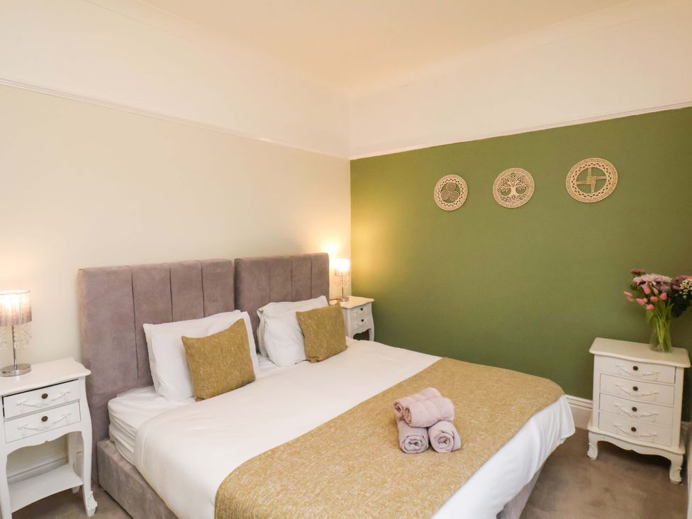 A bedroom with a bed and bedside tables at Wellington Lodge in Bridlington